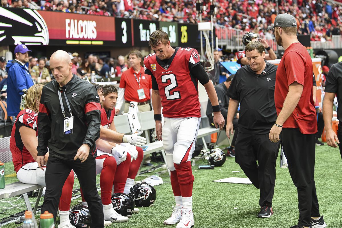 Atlanta Falcons quarterback Matt Ryan is assisted to the medical tent to be checked after being injured against theLos Angeles Rams during the second half at Mercedes-Benz Stadium.