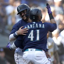 Luis Torrens #22 and Carlos Santana #41 of the Seattle Mariners celebrate their runs against the Oakland Athletics