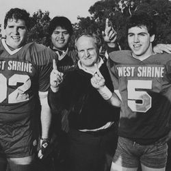 BYU head football coach LaVell Edwards stands with Kyle Morrell (5) after practice in the East-West Shrine game Jan. 2, 1985.