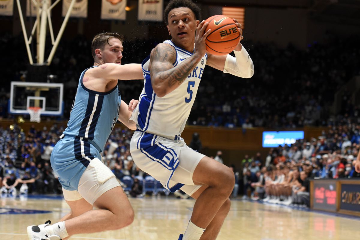 Duke Blue Devils forward Paolo Banchero spins to the basket as The Citadel Bulldogs forward Hayden Brown defends during the second half at Cameron Indoor Stadium.