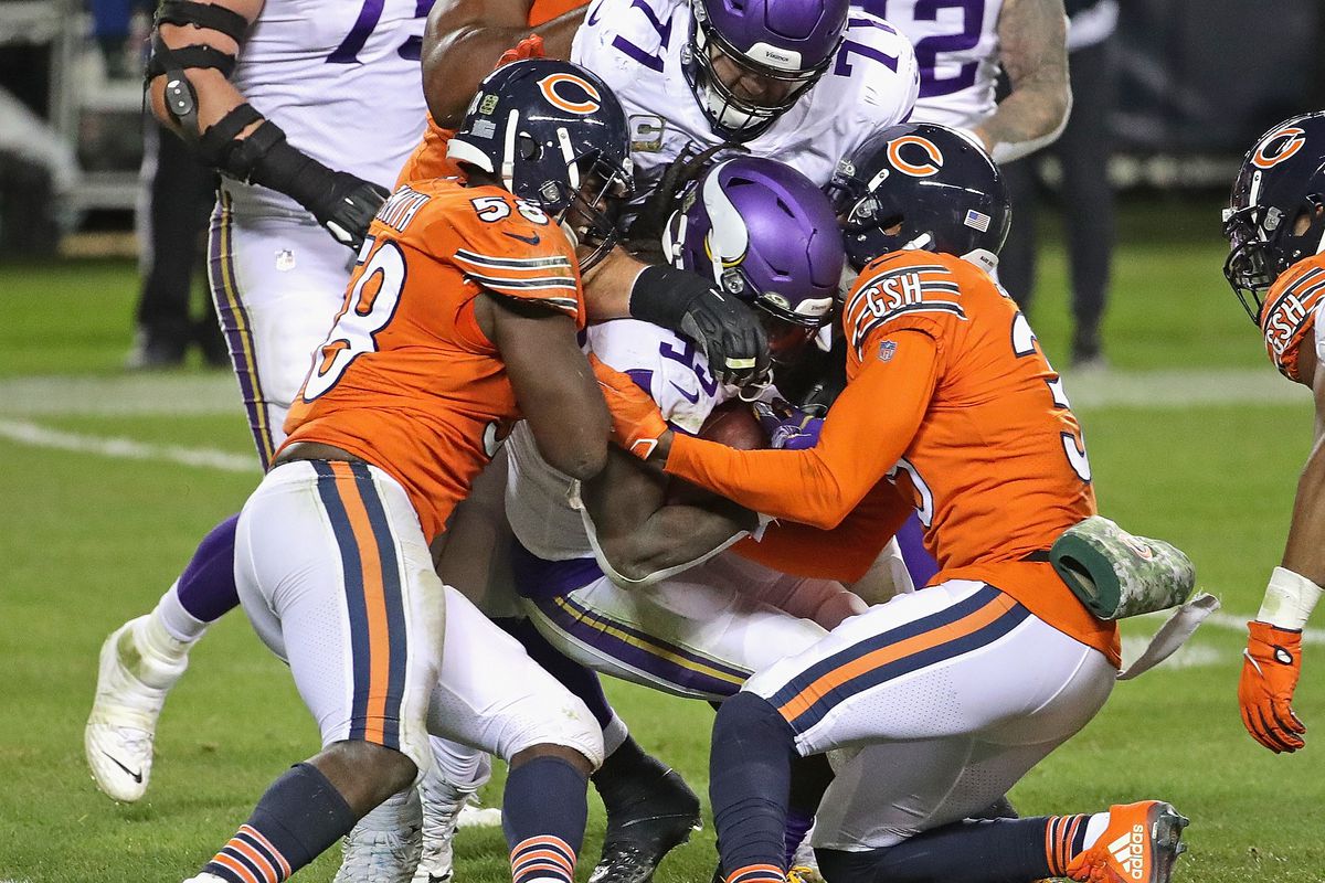 Bears safety Eddie Jackson, right, helps make a tackle Monday night.