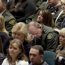 A Utah County sheriff's officer wipes his eyes during the funeral service for Utah County Sheriff's Sgt. Cory Wride at the UCCU Events Center at Utah Valley University in Orem on Wednesday, Feb. 5, 2014. Wride was killed in the line of duty on Thursday while conducting what initially appeared to be a routine traffic stop. Wride was a deputy with the sheriff's office for 19 years and leaves behind a wife, five children and eight grandchildren.