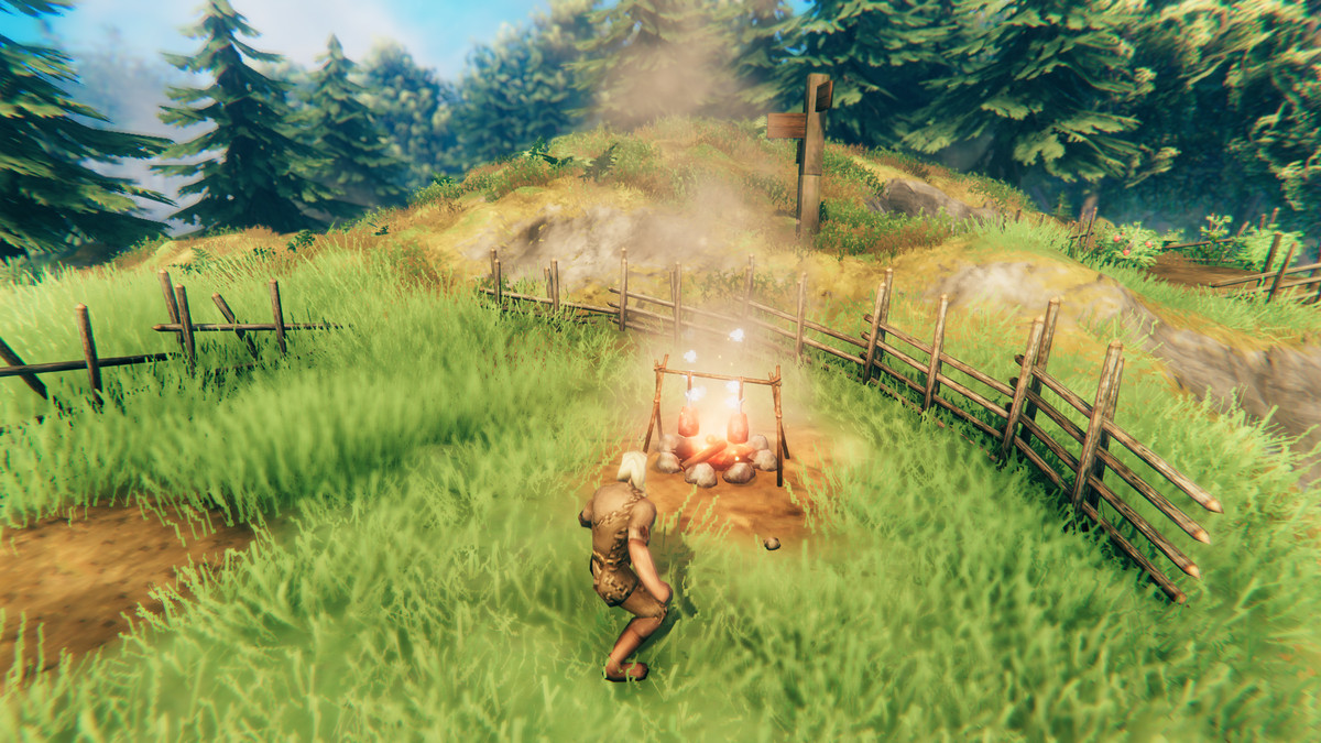 A viking stands next to an open flame in Valheim