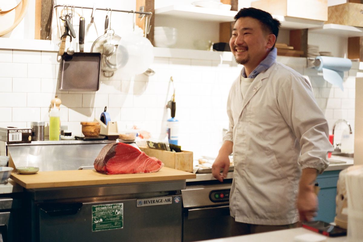 Chef Sun Hong at his Capitol Hill lunch counter By Tae, next to a giant cut of fish.