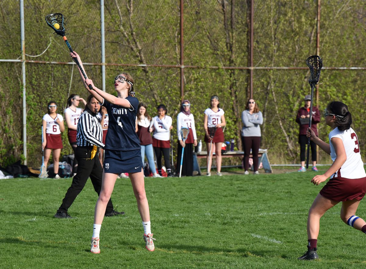 Bridget Boockmeier, 17, left) a Trinity High School senior from Oak Park, catches the ball. Images from April 23, 2019 at Northside College Prep High School, 5501 North Kedzie Ave. in Chicago. | Karie Angell Luc/For the Sun-Times