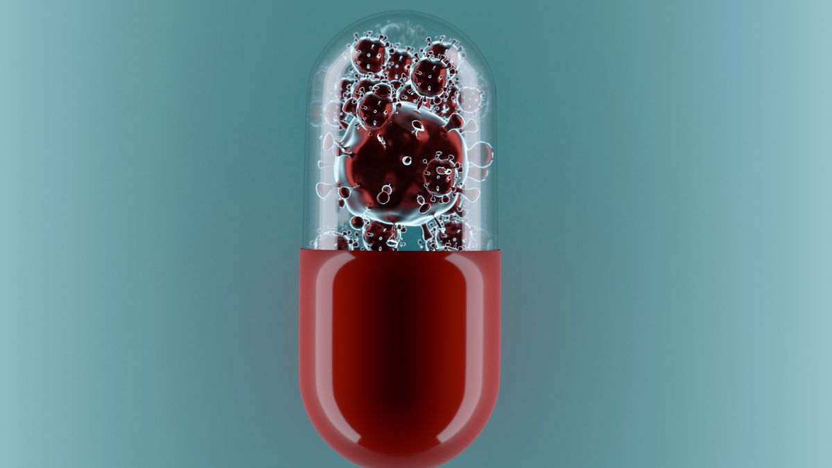 Computer rendering of a pill capsule with enlarged coronavirus particles inside.