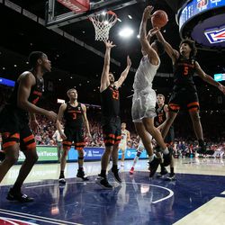Arizona forward Ira Lee, center, has an offensive rebound stripped away by Oregon’s Ethan Thompson (5) during the Arizona-Oregon State game in McKale Center on January 19 in Tucson, Ariz.