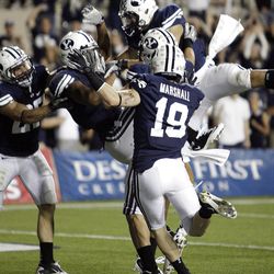Brigham Young Cougars wide receiver Cody Hoffman (2)is mauled after returning a kickoff against UCF  in Provo  Friday, Sept. 23, 2011. BYU won 24-17. 