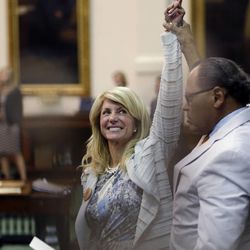 Sen. Wendy Davis, D-Fort Worth, left, who tries to filibuster an abortion bill, reacts as time expires, Wednesday, June 26, 2013, in Austin, Texas. Amid the deafening roar of abortion rights supporters, Texas Republicans huddled around the Senate podium to pass new abortion restrictions, but whether the vote was cast before or after midnight is in dispute. If signed into law, the measures would close almost every abortion clinic in Texas.  (AP Photo/Eric Gay)