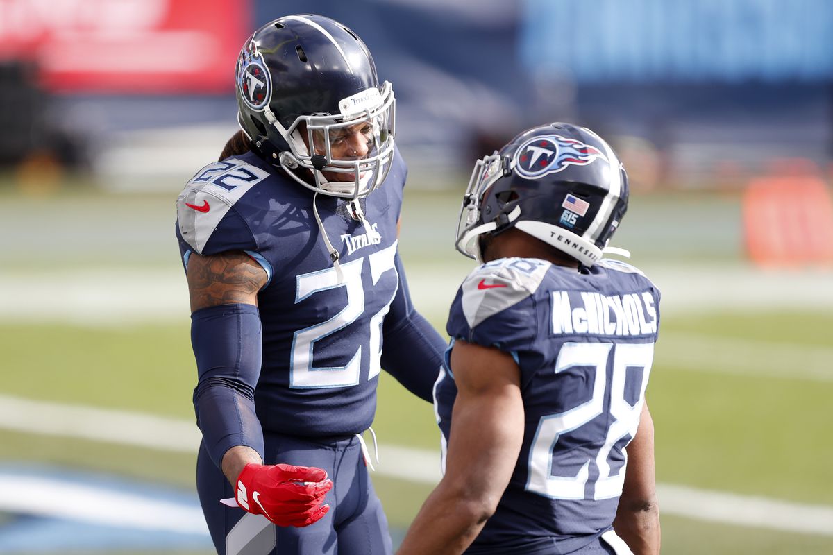 Running backs Derrick Henry #22 and Jeremy McNichols #28 of the Tennessee Titans look on prior to their AFC Wild Card Playoff game against the Baltimore Ravens at Nissan Stadium on January 10, 2021 in Nashville, Tennessee.
