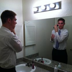 Elder Conner Toolson takes a minute to shave with his electric razor. Elder Toolson, a former Lone Peak High basketball player, is serving in the Texas Fort Worth Mission.