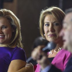Heidi Cruz, left, wife Republican presidential candidate Sen. Ted Cruz, R-Texas, and Carly Fiorina, center, listens a Cruz speaks at a campaign stop, Wednesday, March 30, 2016, in Madison, Wis. 