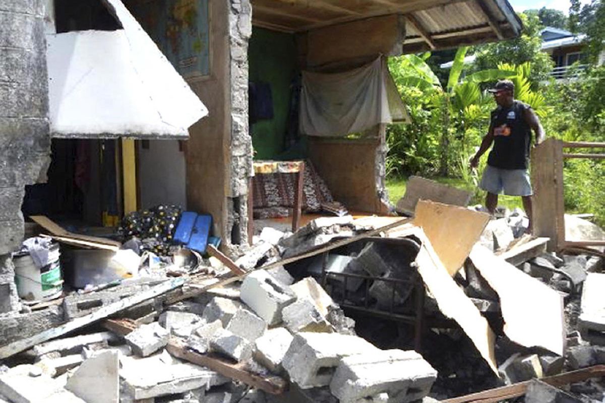 In this photo provided by World Vision Solomon Islands, a house in Kirakira, Solomon Islands, is damaged after an earthquake on Friday, Dec. 9, 2016. Tsunami warnings for several Pacific islands, including those in Hawaii, were canceled Friday after autho