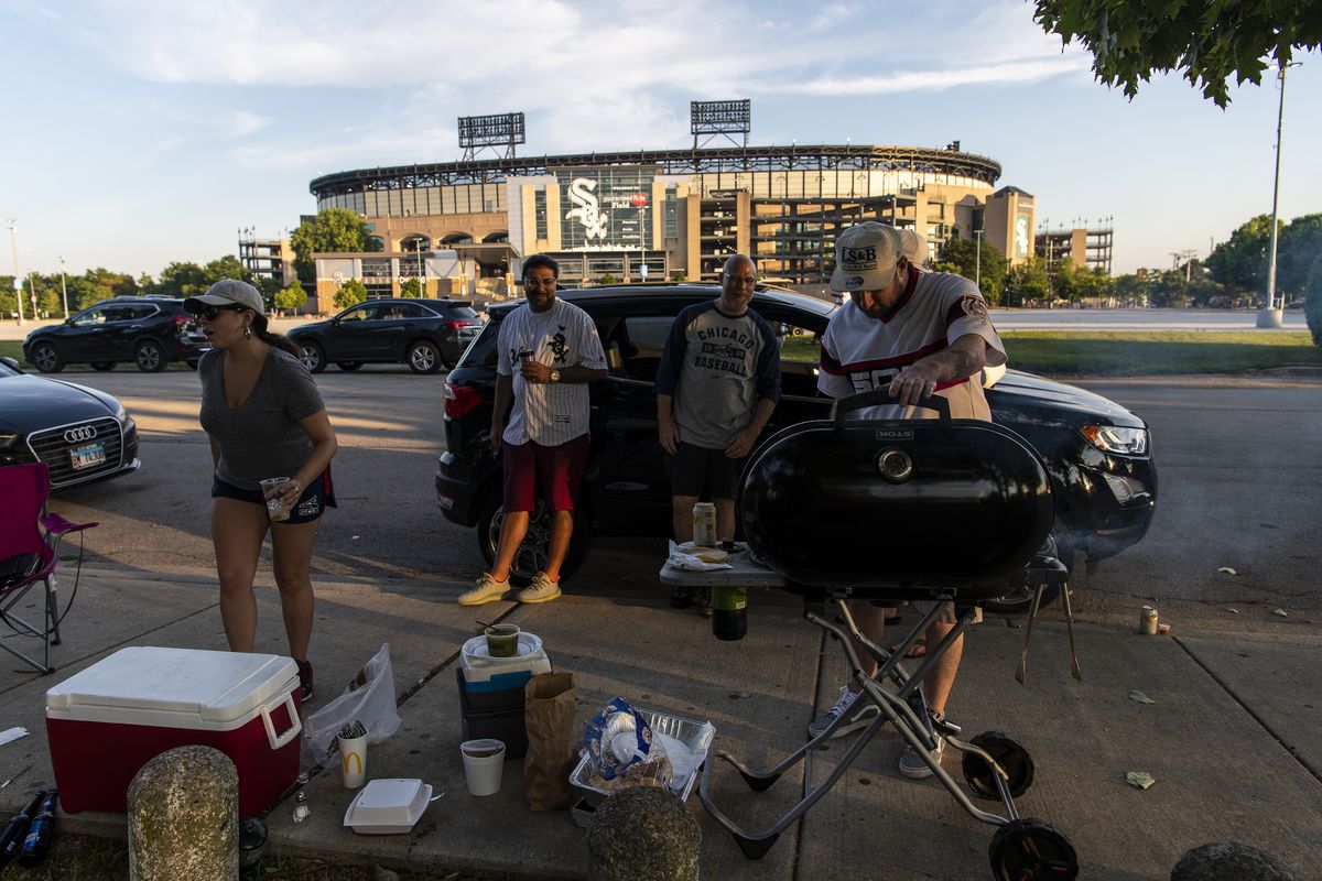 Fans of the Chicago White Sox tailgate outside of Guaranteed Rate Field during the opening day game against the Minnesota Twins, Friday evening, July 24, 2020.