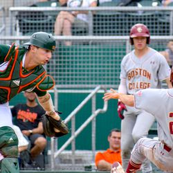 Michael Amditis attempts to tag out a runner at the plate during Miami and Boston College’s game on Saturday. The game would end with a cancellation.