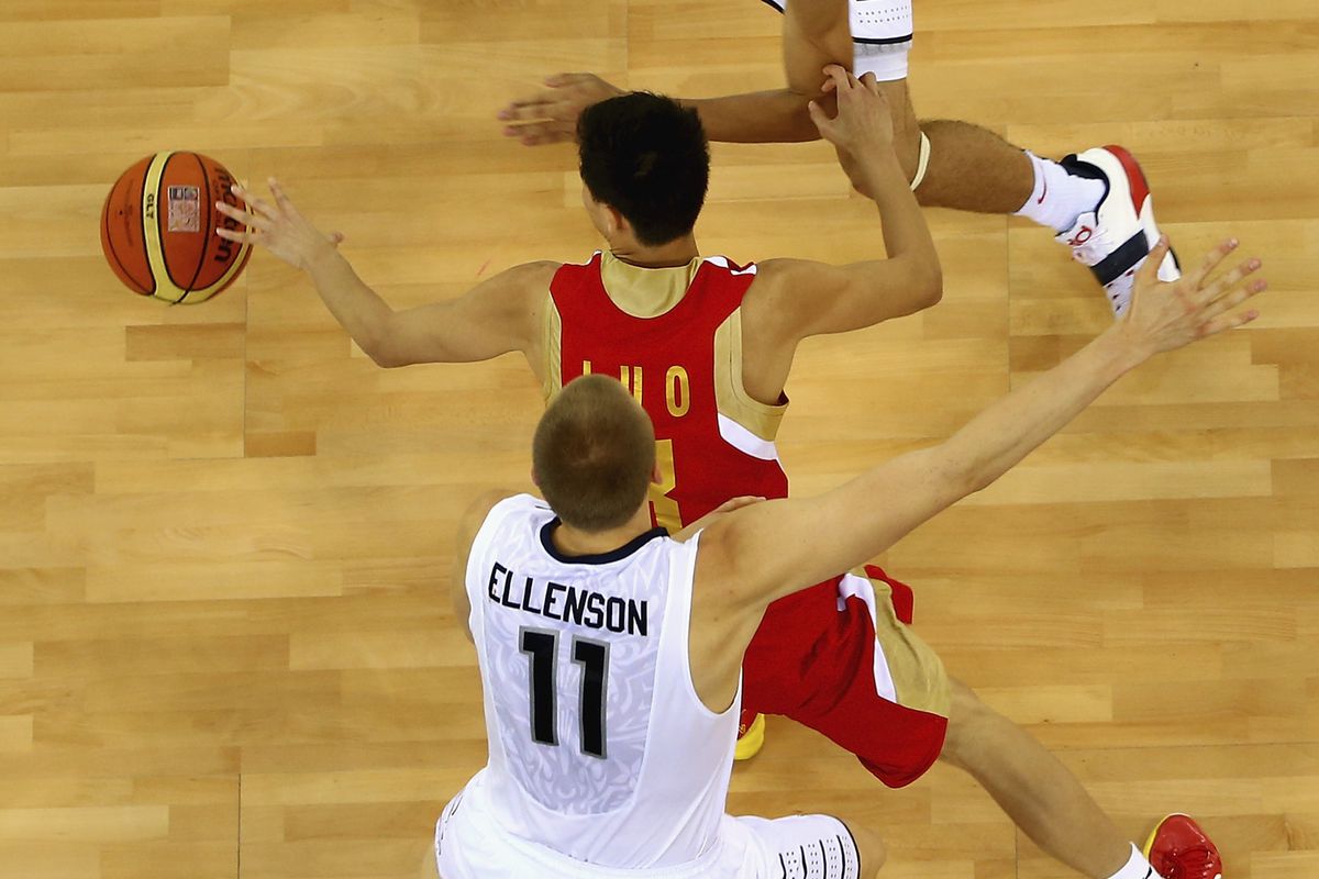 Yongxuan Luo of China controls the ball against Jayon Tatum and Henry Ellenson of the United States during the FIBA U17 World Championships Quarter-Final match between China and the United States of America.