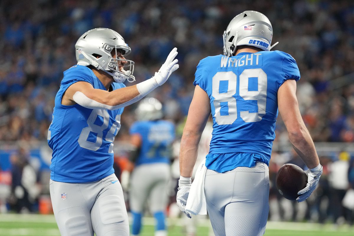 Brock Wright of the Detroit Lions celebrates a touchdown with Shane Zylstra during the first quarter in the game against the Chicago Bears at Ford Field on January 01, 2023 in Detroit, Michigan.