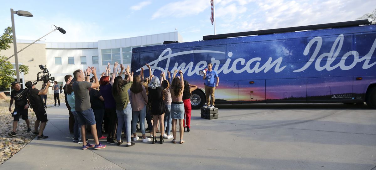 Collin DeClerk, production assistant, tries to get the crowd excited while filming before “American Idol” auditions outside of the Northwest Community Center in Salt Lake City on Thursday, Aug. 29, 2019.