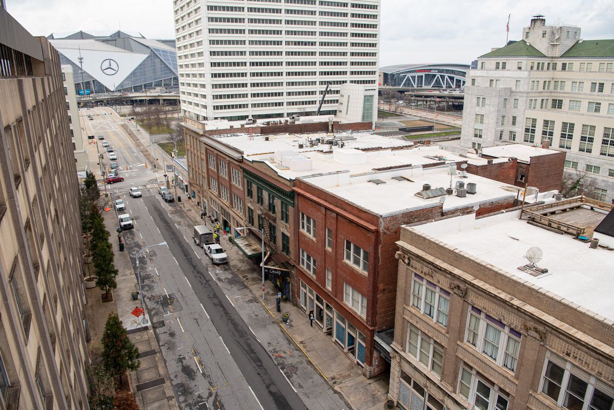 Overlooking the three story historic hotel row brick buildings along Mitchell Street in Downtown ATlanta, which are being revitalized into new restaurants, retail shops, and studio spaces.