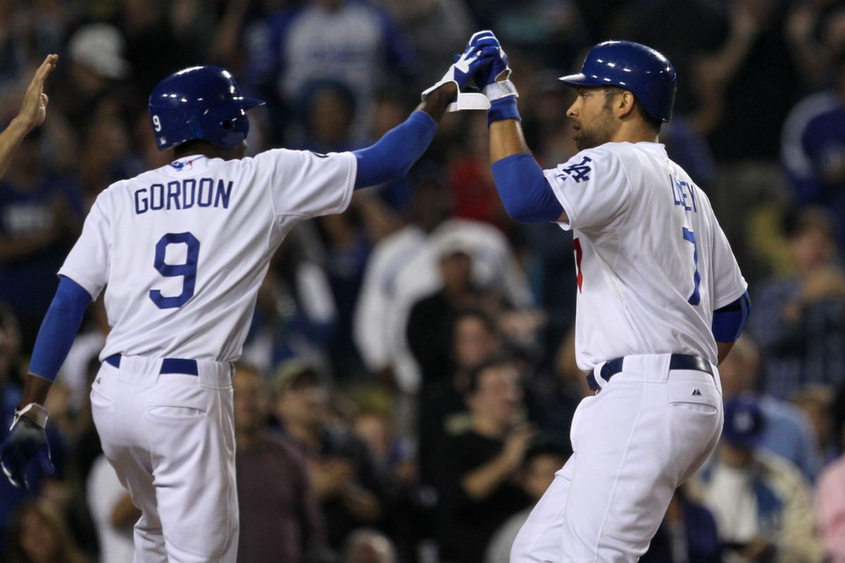 Dee Gordon and James Loney celebrate Loney's first career pinch-hit home run.
