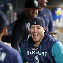 Ty France #23 of the Seattle Mariners reacts after giving a water bath to the coaches after beating Texas Rangers 10-9 during the eleventh inning