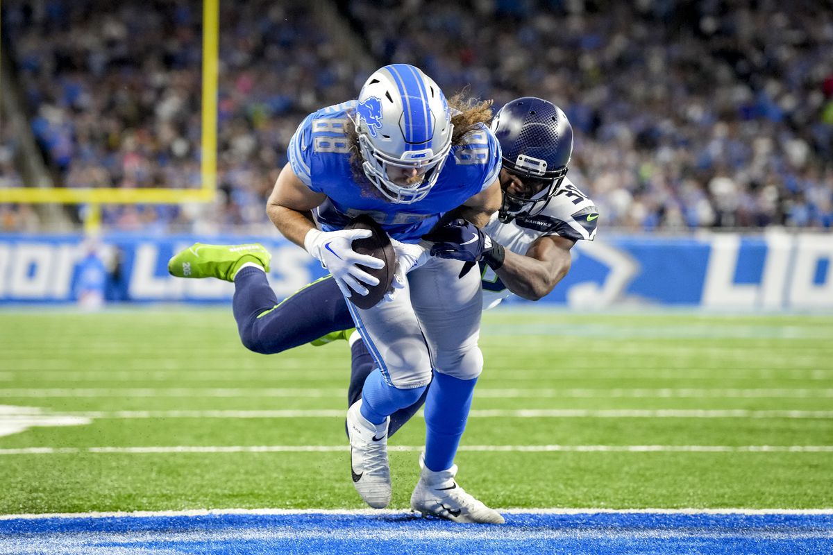 T.J. Hockenson #88 of the Detroit Lions scores a two-point conversion against Mike Jackson #30 of the Seattle Seahawks during the second half of the game at Ford Field on October 02, 2022 in Detroit, Michigan.