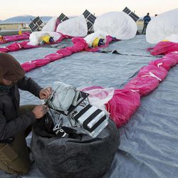 In this June 10, 2013 photo released by Google, Jordan Miceli prepares electronics to launch balloons in Tekapo, New Zealand. Google is testing the balloons which sail in the stratosphere and beam the Internet to Earth. 
