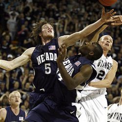 Nevada's Luke Babbitt and Dario Hunt and Utah State's Brady Jardine reach for the rebound during the first half of a basketball game at the Dee Glen Smith Spectrum in Logan Saturday. The Aggies defeated the Wolfpack 76-65.