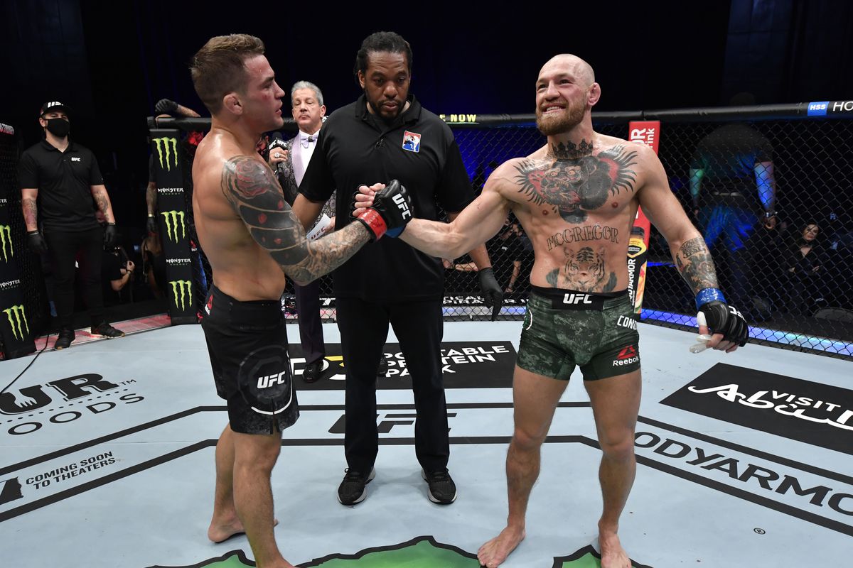 Dustin Poirier and Conor McGregor shake hands after their UFC 257 main event bout.