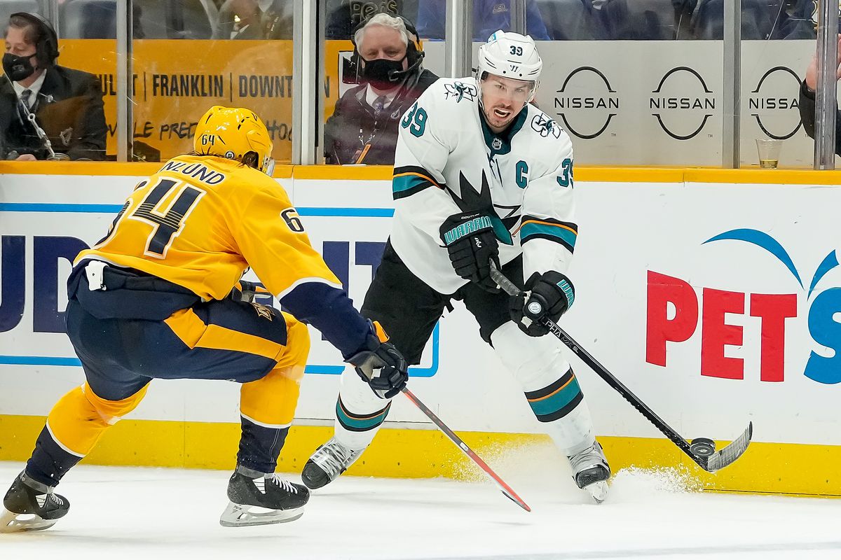 Logan Couture #39 of the San Jose Sharks skates against Mikael Granlund #64 of the Nashville Predators during an NHL game at Bridgestone Arena on October 26, 2021 in Nashville, Tennessee.