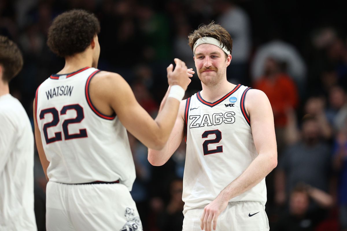 Drew Timme #2 of the Gonzaga Bulldogs celebrates with Anton Watson #22 after defeating the Memphis Tigers 82-78 during the second half in the second round of the 2022 NCAA Men’s Basketball Tournament at Moda Center on March 19, 2022 in Portland, Oregon.