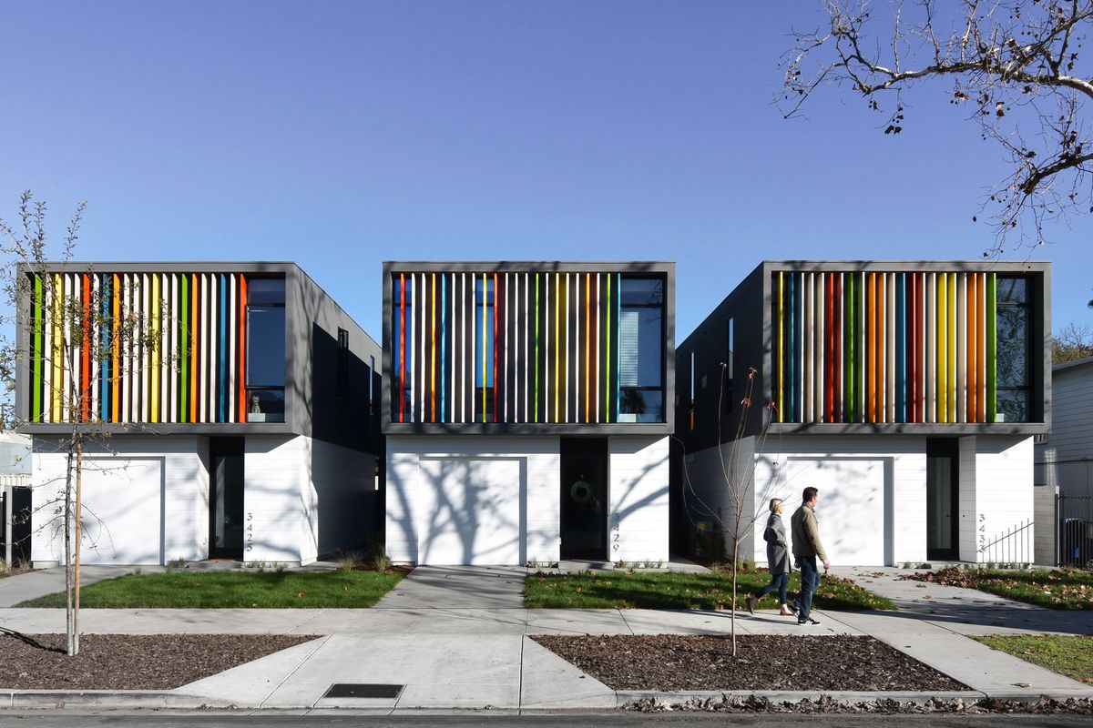 Three standalone homes with rainbow color facade