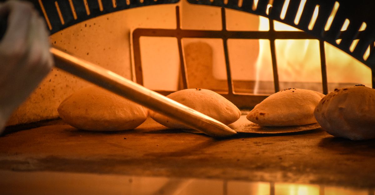 Pita bread in a wood-fired oven.