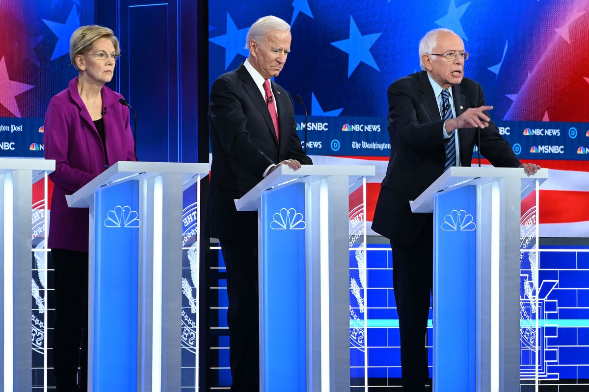 Former Vice President Joe Biden and Sens. Elizabeth Warren and Bernie Sanders share the stage at the fifth Democratic debate in Atlanta last year.