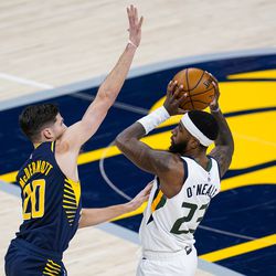 Utah Jazz forward Royce O’Neale (23) passes over Indiana Pacers forward Doug McDermott (20) during the first half of an NBA basketball game in Indianapolis, Sunday, Feb. 7, 2021. 