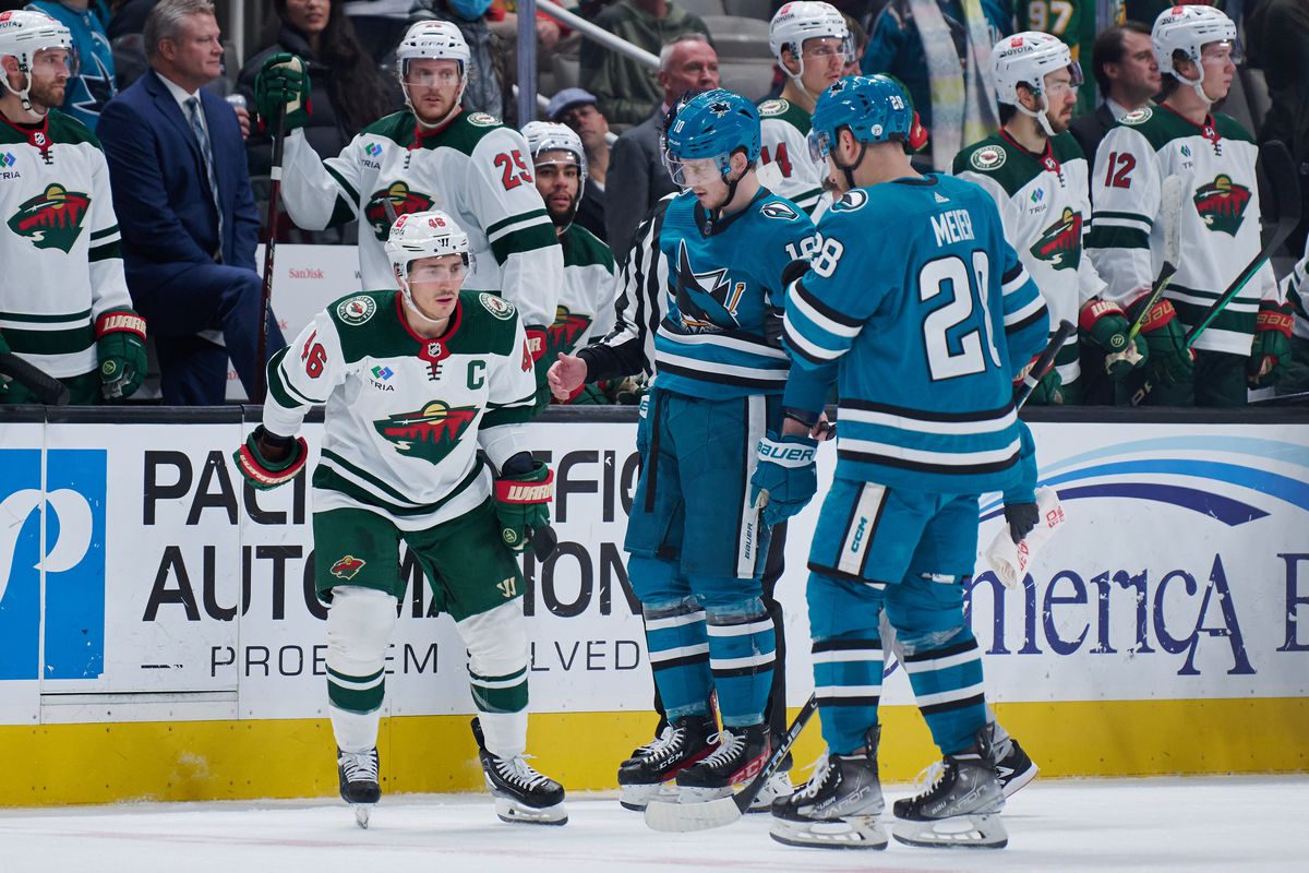San Jose Sharks left wing Evgeny Svechnikov (10) is helped to the bench with an injury after a hard check by Minnesota Wild defenseman Calen Addison (2) (not pictured) during the second period at SAP Center at San Jose.