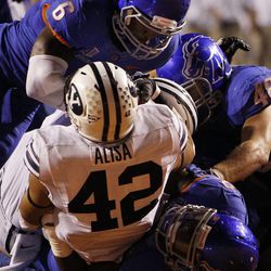 Michael Alisa of the Brigham Young Cougars is tackled near his own goal line during NCAA football in Boise, Thursday, Sept. 20, 2012. Alisa and teammate Jamaal Williams will compete for carries in the BYU backfield this year.