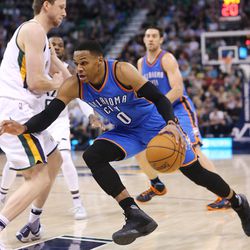 Oklahoma City Thunder guard Russell Westbrook (0) drives around Utah Jazz forward Joe Ingles (2) as the Jazz and the Thunder play at Vivint Smart Home arena in Salt Lake City on Wednesday, Dec. 14, 2016.