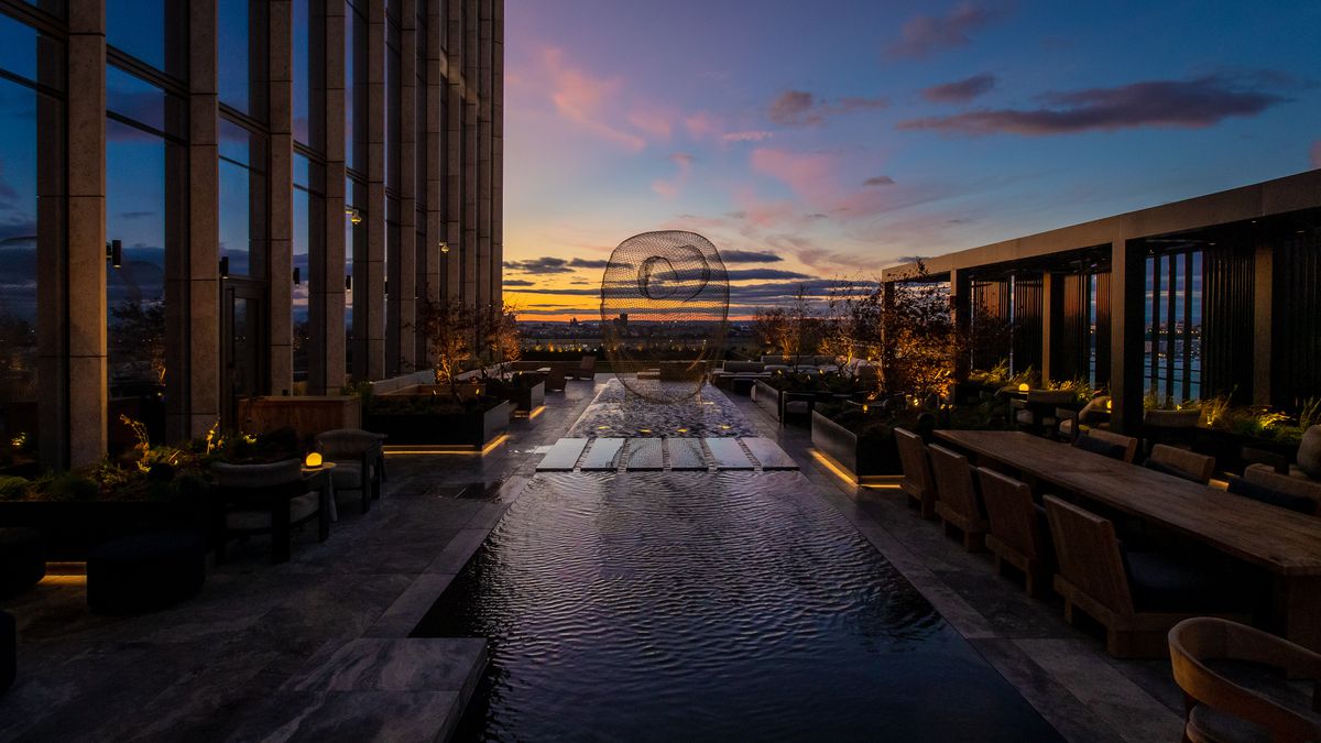 The sun sets behind the Hudson at Electric Lemon’s outdoor terrace, decked out with a rectangular reflecting pool