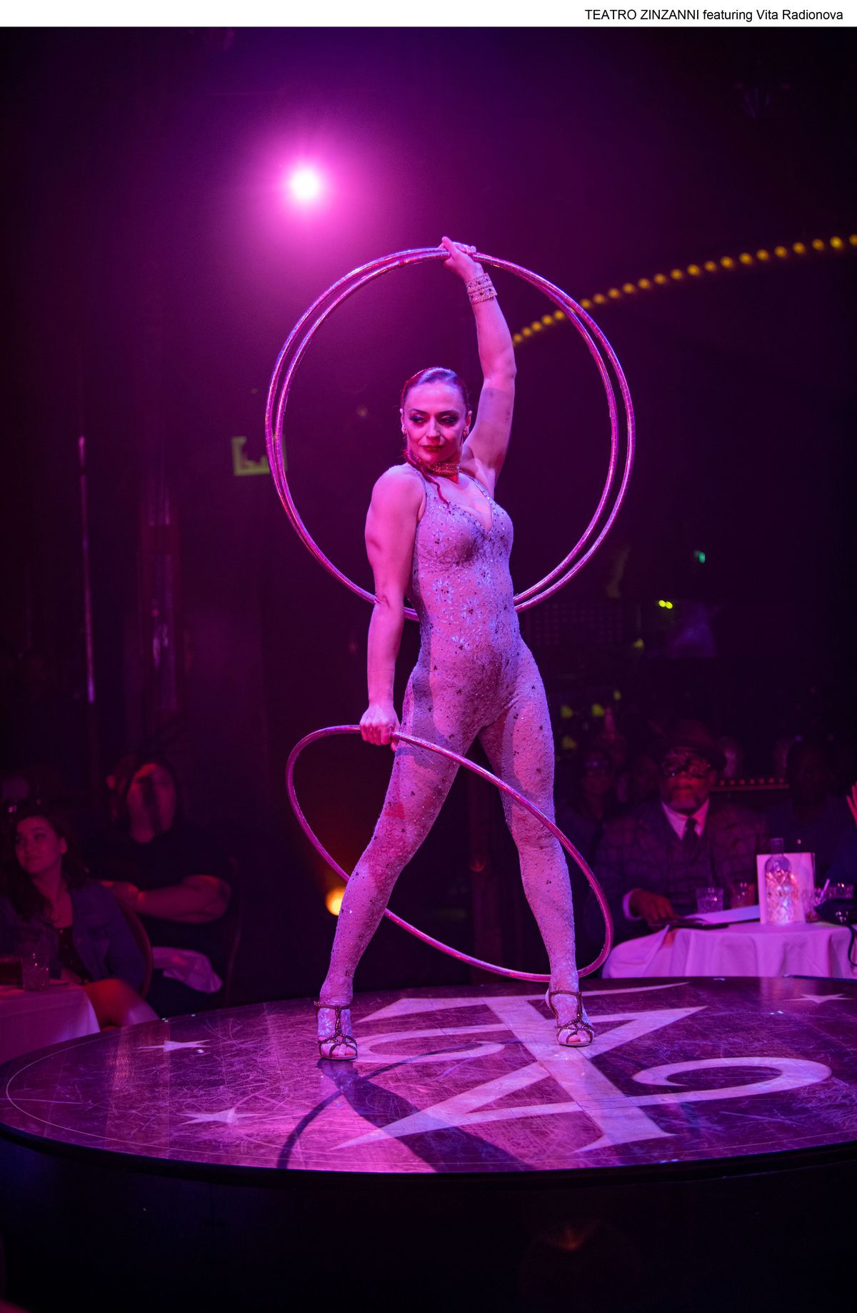 Contortionist Vita Radionova is a beast at hula-hooping — adding the thick circles until you’ve lost count and she is consumed by a spiraling hoop barrel — at Teatro Zinzanni, a 2 1/2-hour feast for the senses running through Nov. 28 at the downtown Cambria Hotel.