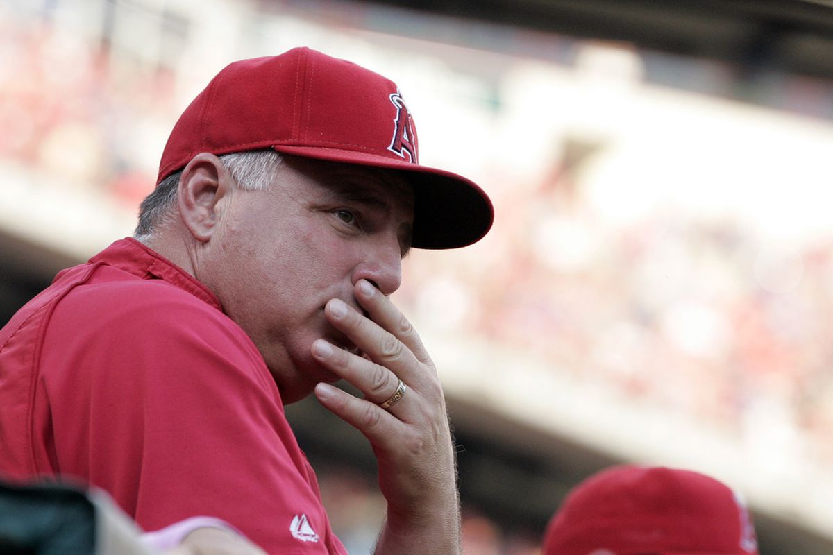 May 13, 2012; Arlington, TX, USA; Los Angeles Angels manager Mike Scioscia (14) watches the game during the first inning of the game against the Texas Rangers at Rangers Ballpark. Mandatory Credit: Tim Heitman-US PRESSWIRE
