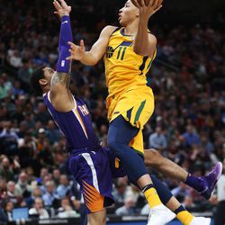 Utah Jazz guard Dante Exum (11) drives on Phoenix Suns guard Tyler Ulis (8)  in Salt Lake City on Thursday, March 15, 2018. The Jazz 116-88.