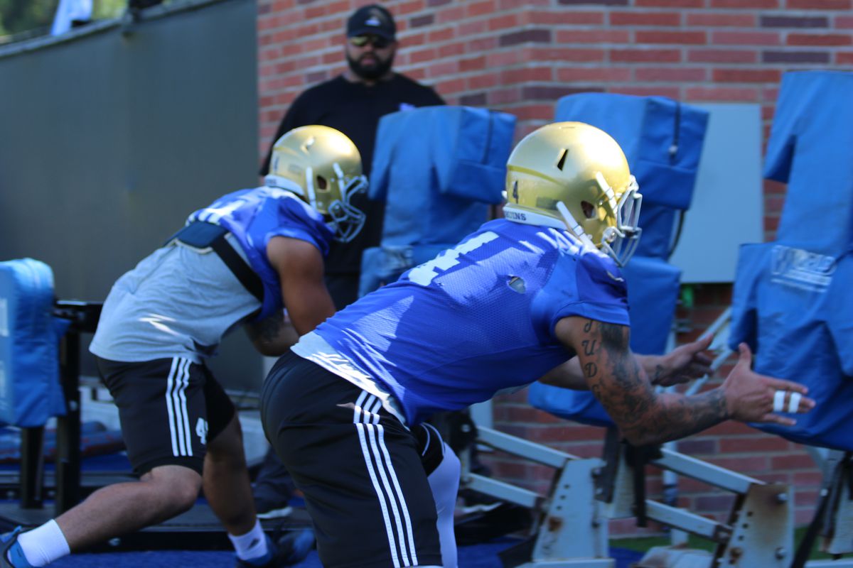 Cameron Judge (4) hits the sled during UCLA's Fall Training Camp.