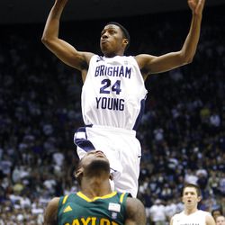 BYU's #24 Damarcus Harrison flies in for a dunk over Baylor's #55 Pierre Jackson as BYU and Baylor play Saturday, Dec. 17, 2011 in the Marriott Center in Provo. Baylor won 86-83.