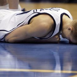 Utah's Andrei Kirilenko lays on the floor after breaking his left wrist in game action against Washington Wizards March 24, 2005, in Salt Lake City.