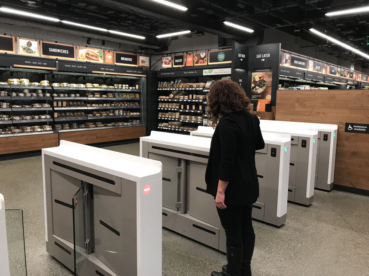 A shopper scans her phone to enter the new Amazon Go convenience store in Seattle.