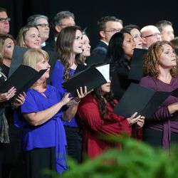 Choir members sing at a devotional with President Russell M. Nelson and others at the Amway Center in Orlando, Florida, on Sunday, June 9, 2019.
