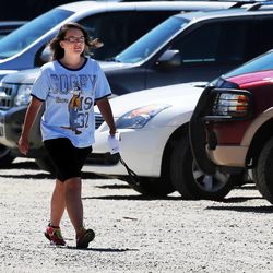Bailey Arnold wears a Disney t-shirt as she leaves the funeral of Alex and Benjie Vidinhar in Ogden, Monday, June 3, 2013.
