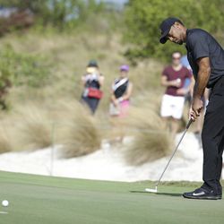 Tiger Woods putts on the first hole during the first round at the Hero World Challenge golf tournament, Thursday, Dec. 1, 2016, in Nassau, Bahamas. 