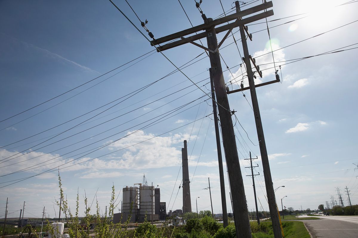 Transmission lines carry electricity from NRG Energy’s Joliet Station power plant in 2015 in Joliet, Illinois. 